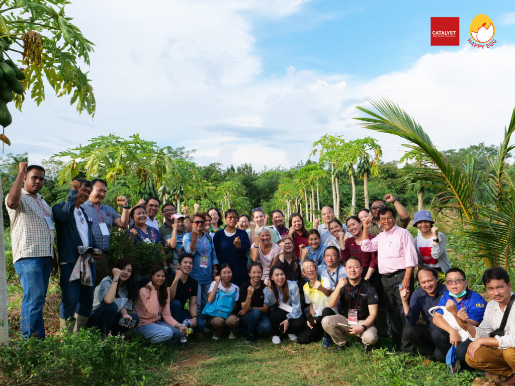 Animal advocates pose for a photo in a tropical setting